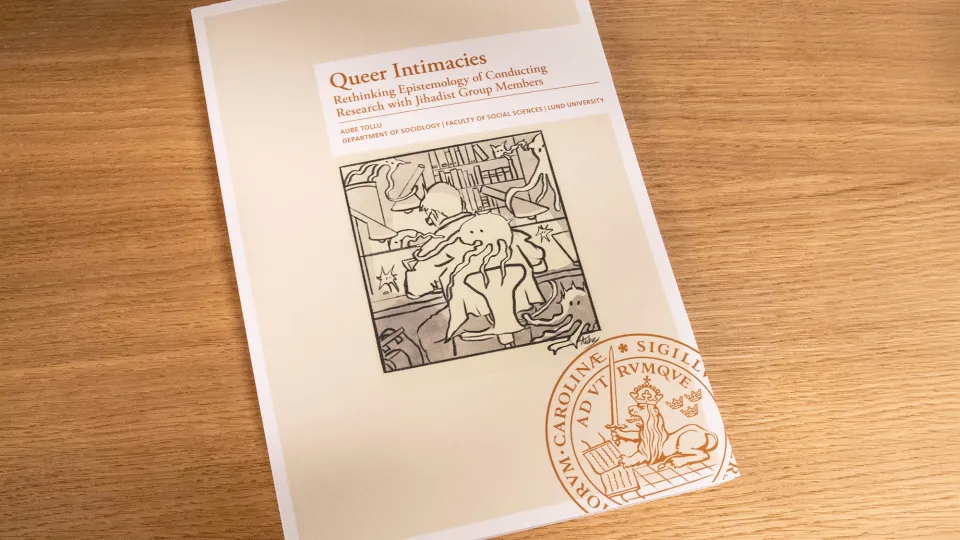 The thesis in book form on a wooden table.