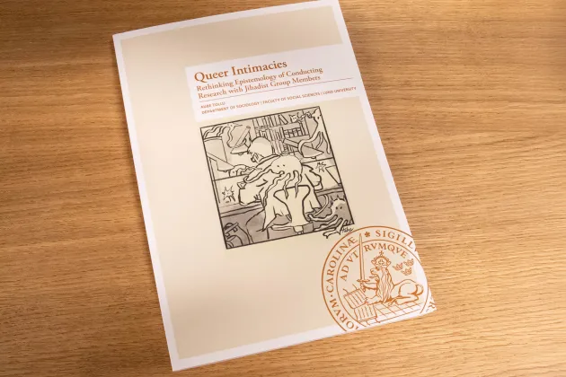 The thesis in book form on a wooden table.