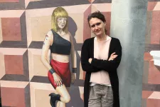  Petra Östergren by a mural of a street worker. 