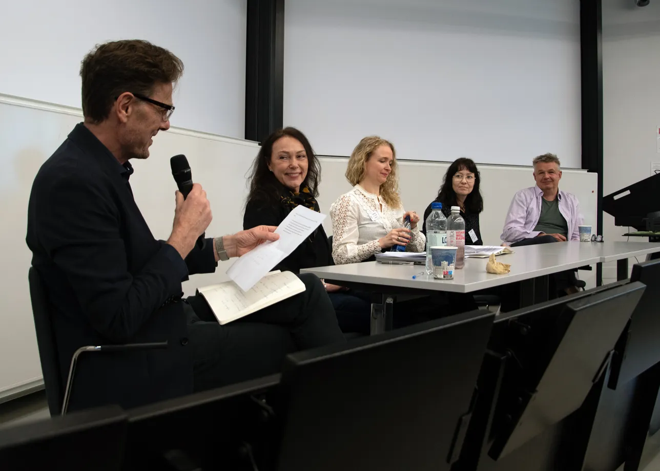 A panel of discussants at a conference.