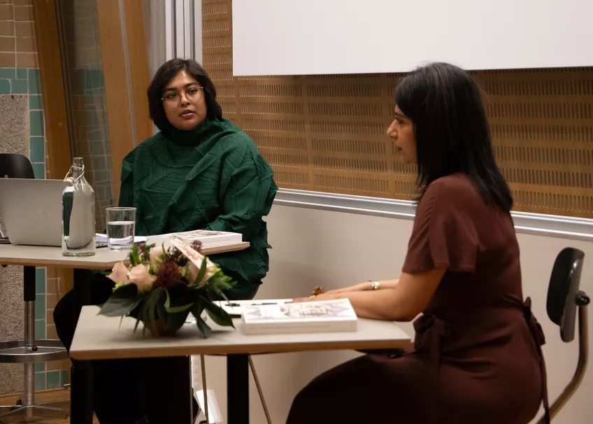 Uzma Kazi answering a question from external reviewer Tahseen Shams in a lecture hall.