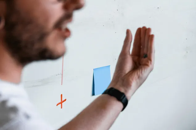 En man pekar på något på en whiteboard.